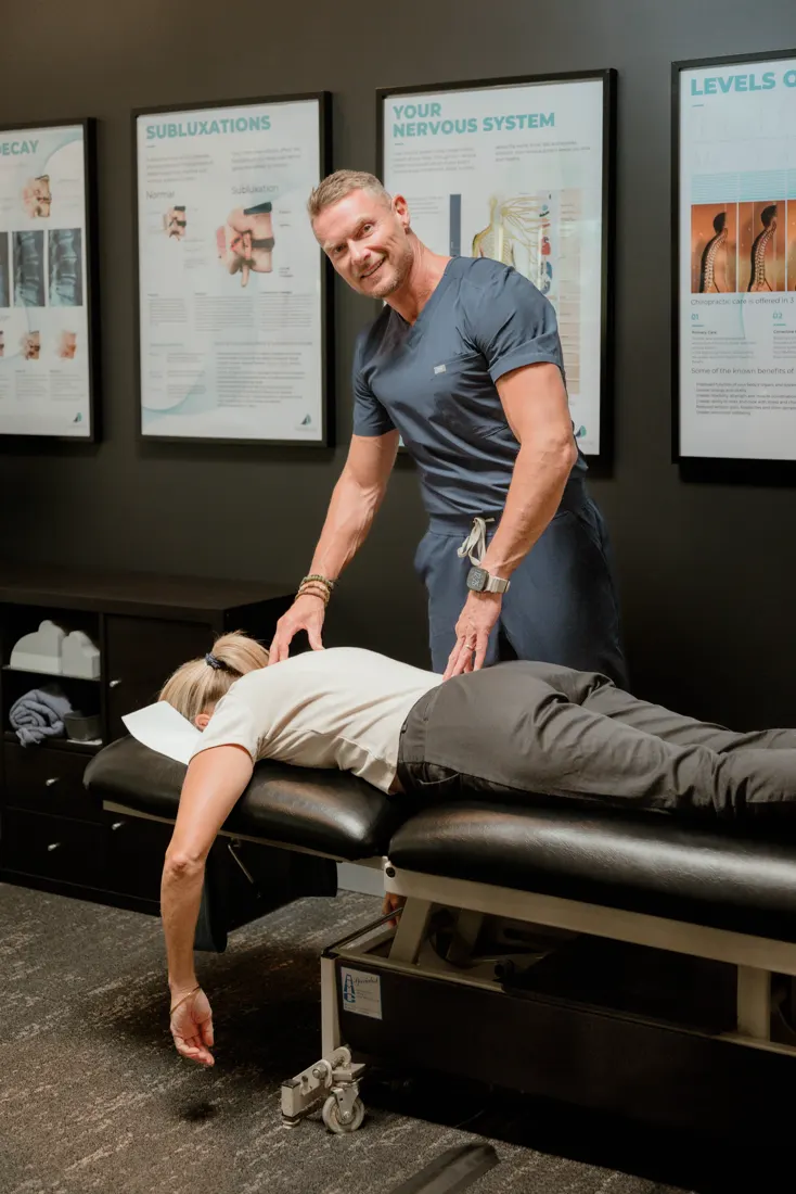 Dr Ben Carvosso assessing a practice member's low back and pelvis