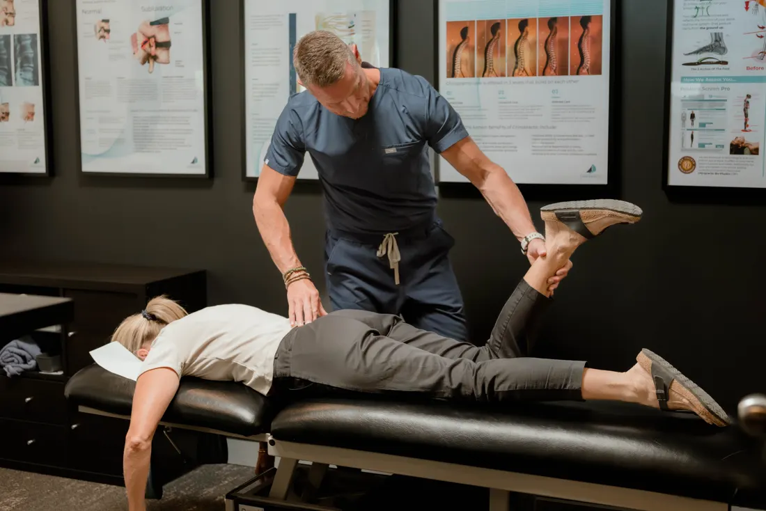 Dr Ben Carvosso assessing a practice member's low back and leg
