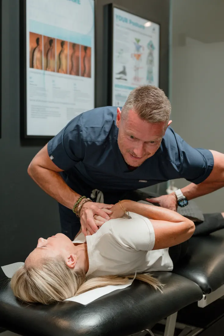 Dr Ben Carvosso assessing a practice member's neck