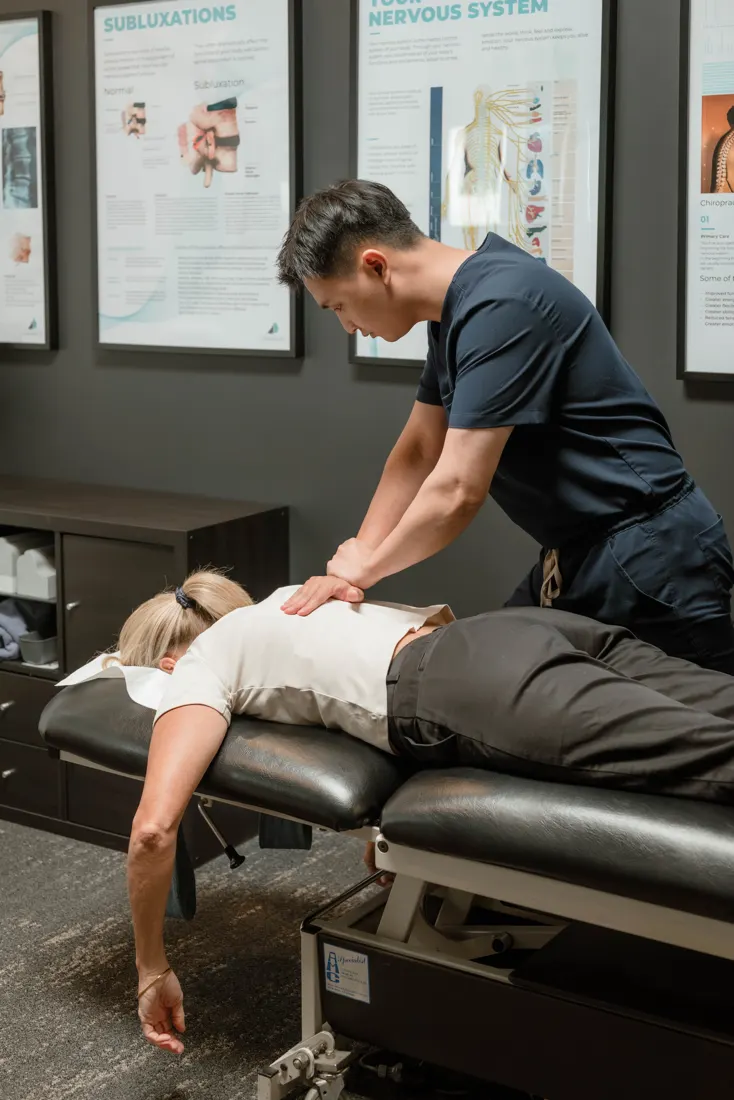 Dr Ryan Tan adjusting a practice member's low back