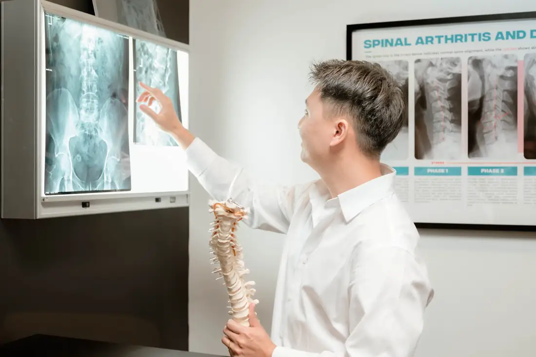 Dr Ryan Tan going through spinal X-rays on the lightbox