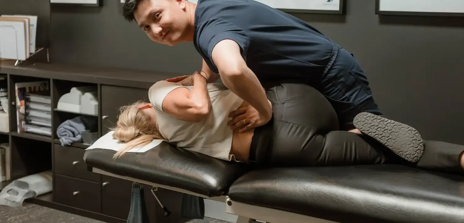 Dr Ryan Tan adjusting a practice member